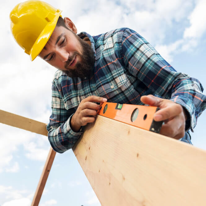 worker-with-hard-hat-level-checking-roof-timber(1)